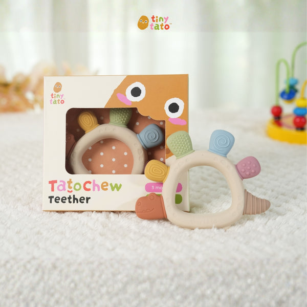 TatoChew silicone baby teether next to its box